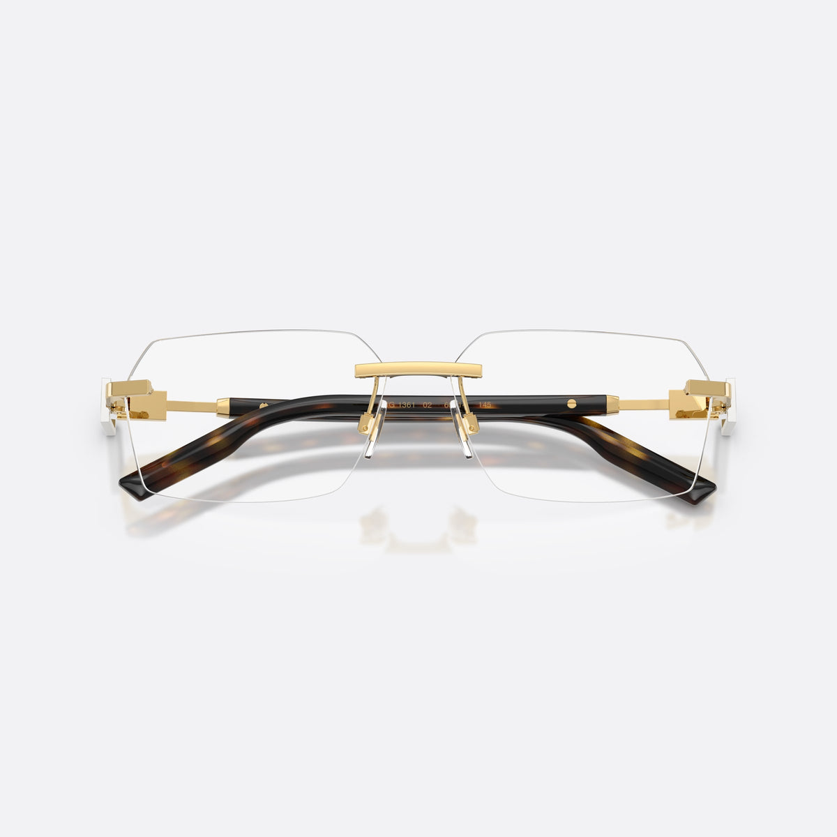 Dolce & Gabbana DG1361 02 eyeglasses, gold rectangle frame for men, plain gold-tone bar bridge, tapered temples with plaque, folded