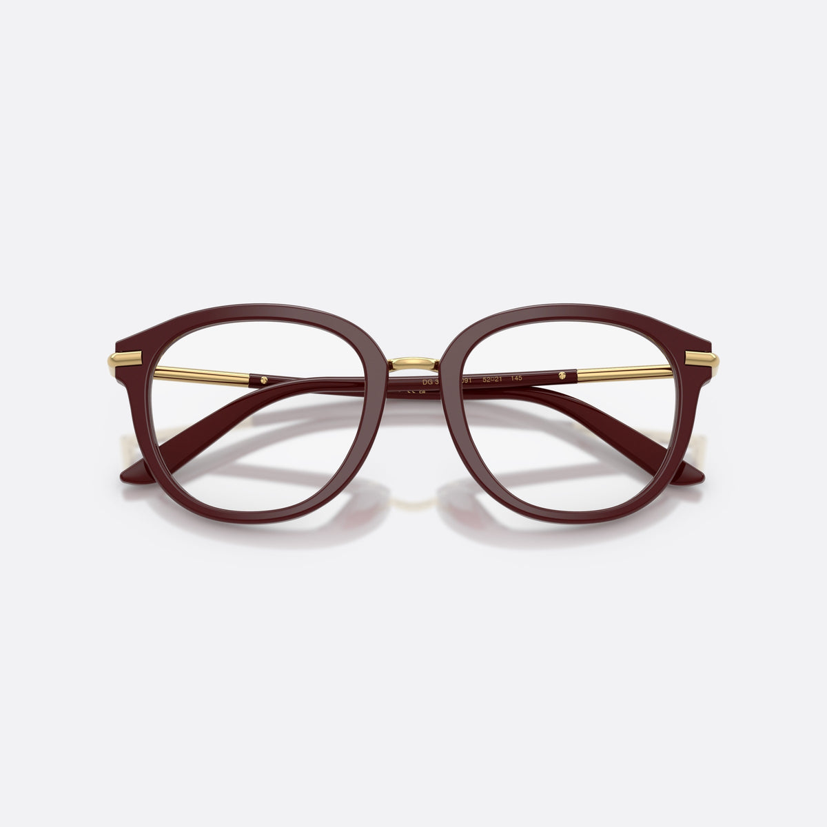 Dolce & Gabbana DG3410 3091 eyeglasses, red phantos frame for women, metal saddle bridge, brand lettering on temples, folded