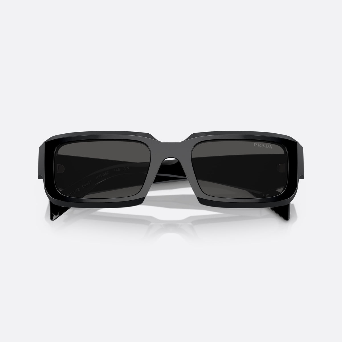 Prada PR 27ZS 16K-08Z sunglasses, black irregular frame for men, plain bridge, brand lettering on temples, full-rim frame, folded