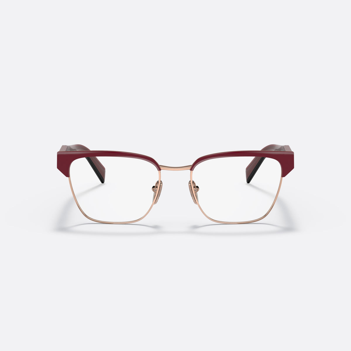 Prada PR 65YV 16A1O1 eyeglasses, red irregular frame for women, saddle-style metal bridge, brand lettering on the temples, front view