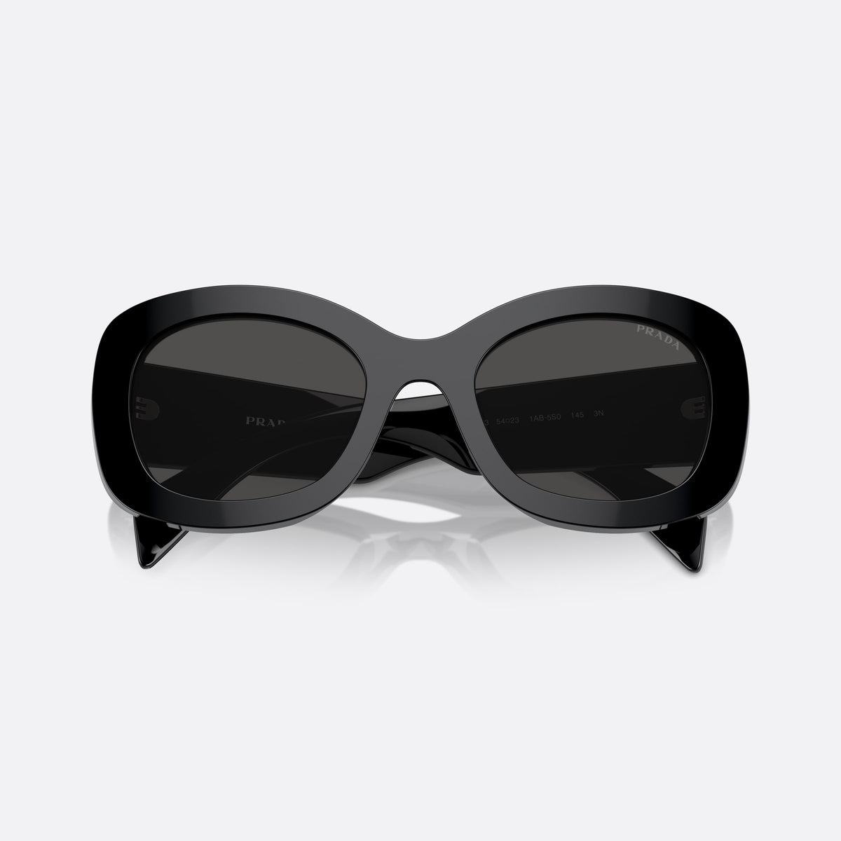 Prada PR A13S 1AB-5S0 B sunglasses, black oval frame for women, plain saddle style bridge, raised brand lettering on temples, folded