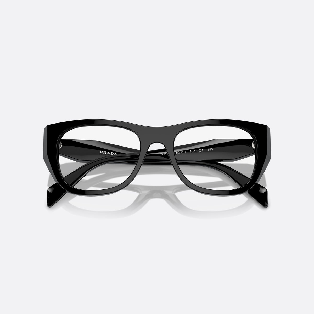 Prada PR A18V 16K-1O1 eyeglasses, black irregular frame for women, plain bridge, low saddle profile, brand lettering on temples