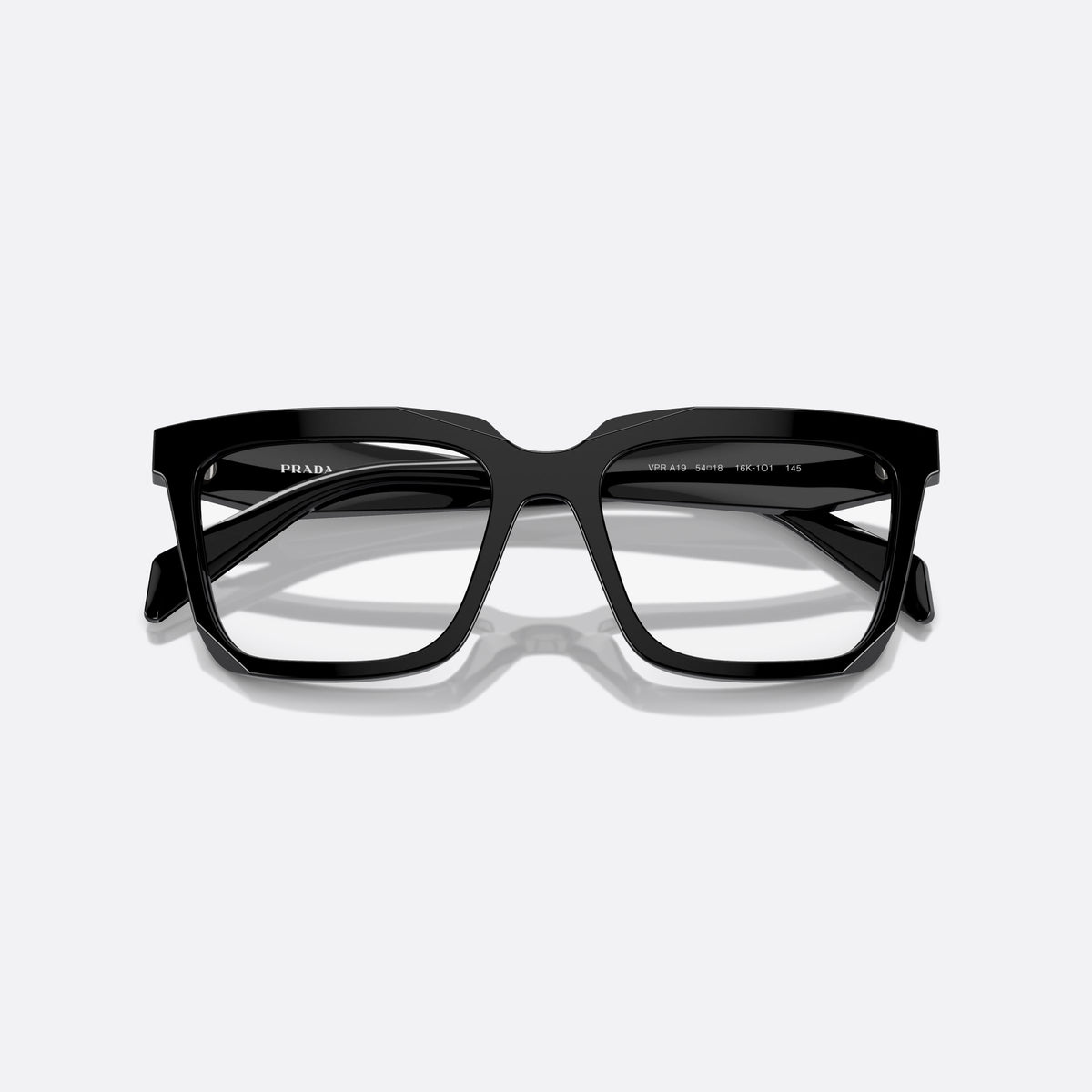 Prada PR A19V 16K1O1 eyeglasses, black squared frame for women, plain double bridge, triangular brand logo plaque, folded