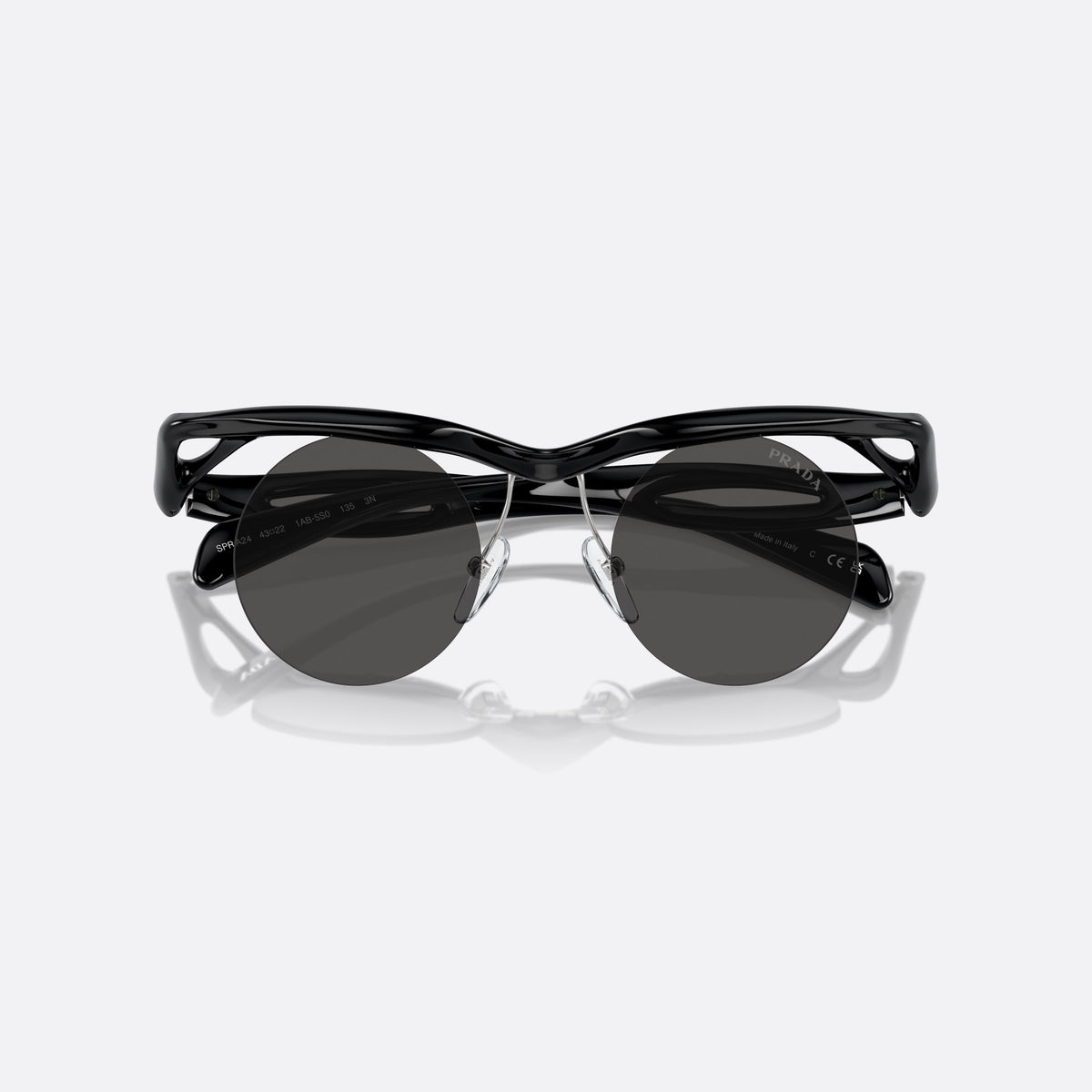 Prada PR A24S 1AB5S0 sunglasses, black round frame for women, thick wavy bridge, brand lettering on temples, folded