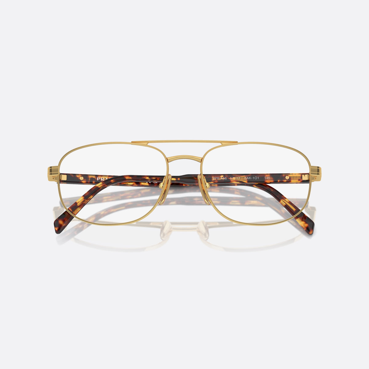 Prada PR A56V 5AK1O1 eyeglasses, gold round frame for men, double bridge with top bar, brand lettering on temples, folded