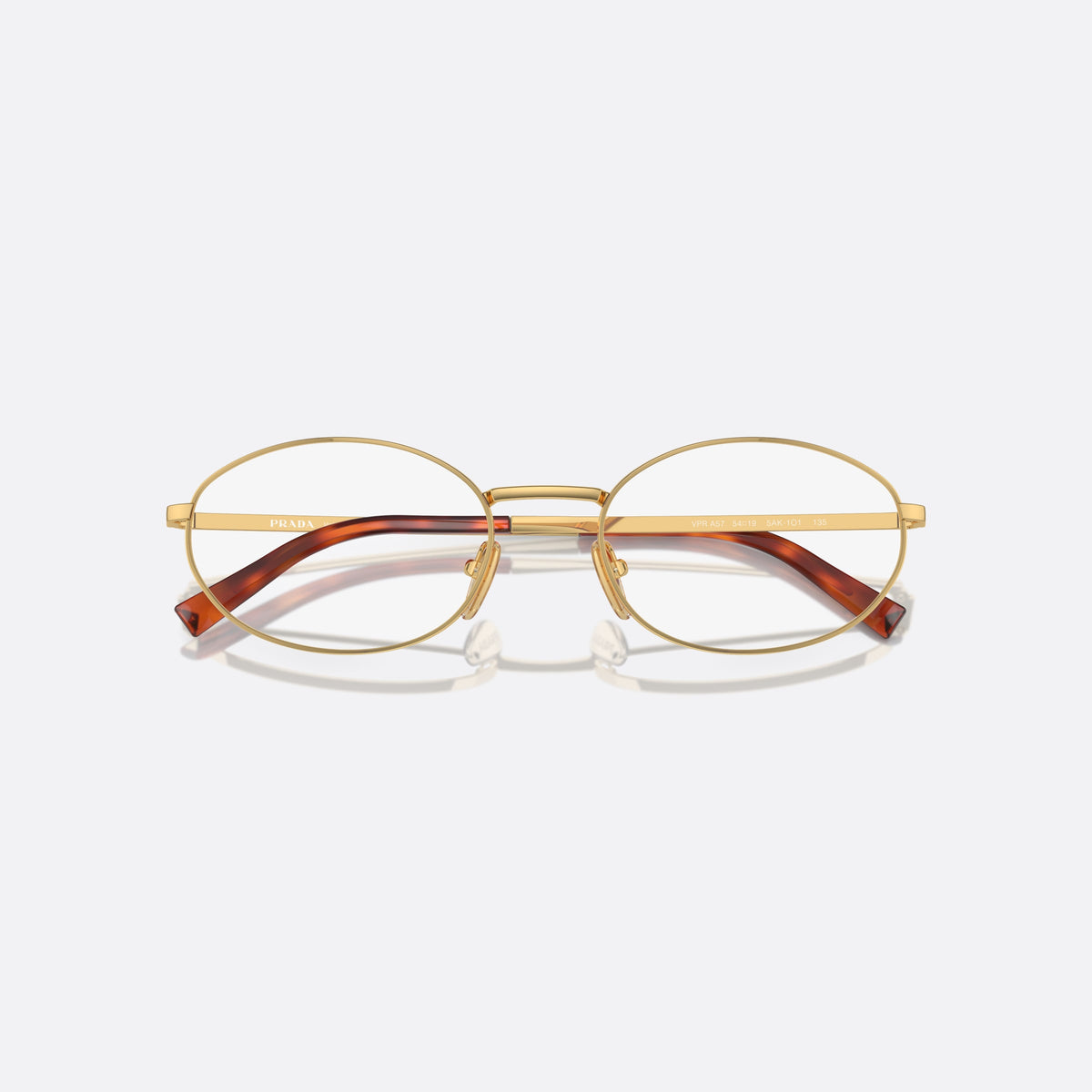 Prada PR A57V 5AK1O1 eyeglasses, gold round frame for women, plain metal bridge, brand lettering on temples, folded