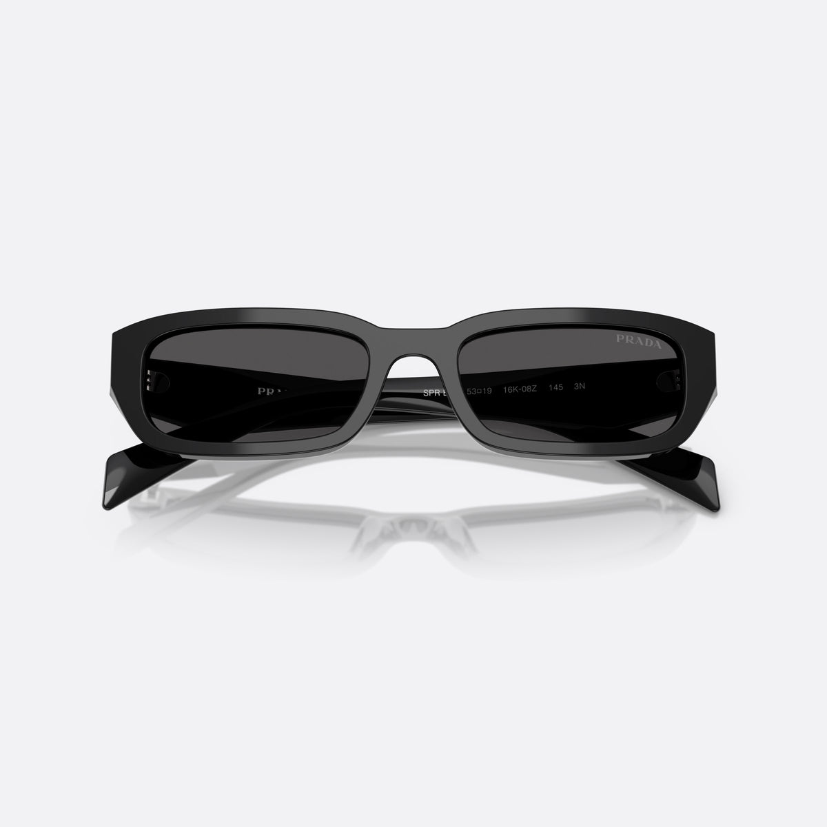Prada PR B06S 16K08Z BLGR sunglasses, black rectangle frame for women, plain bridge, integrated into frame, wide tapered temples, folded