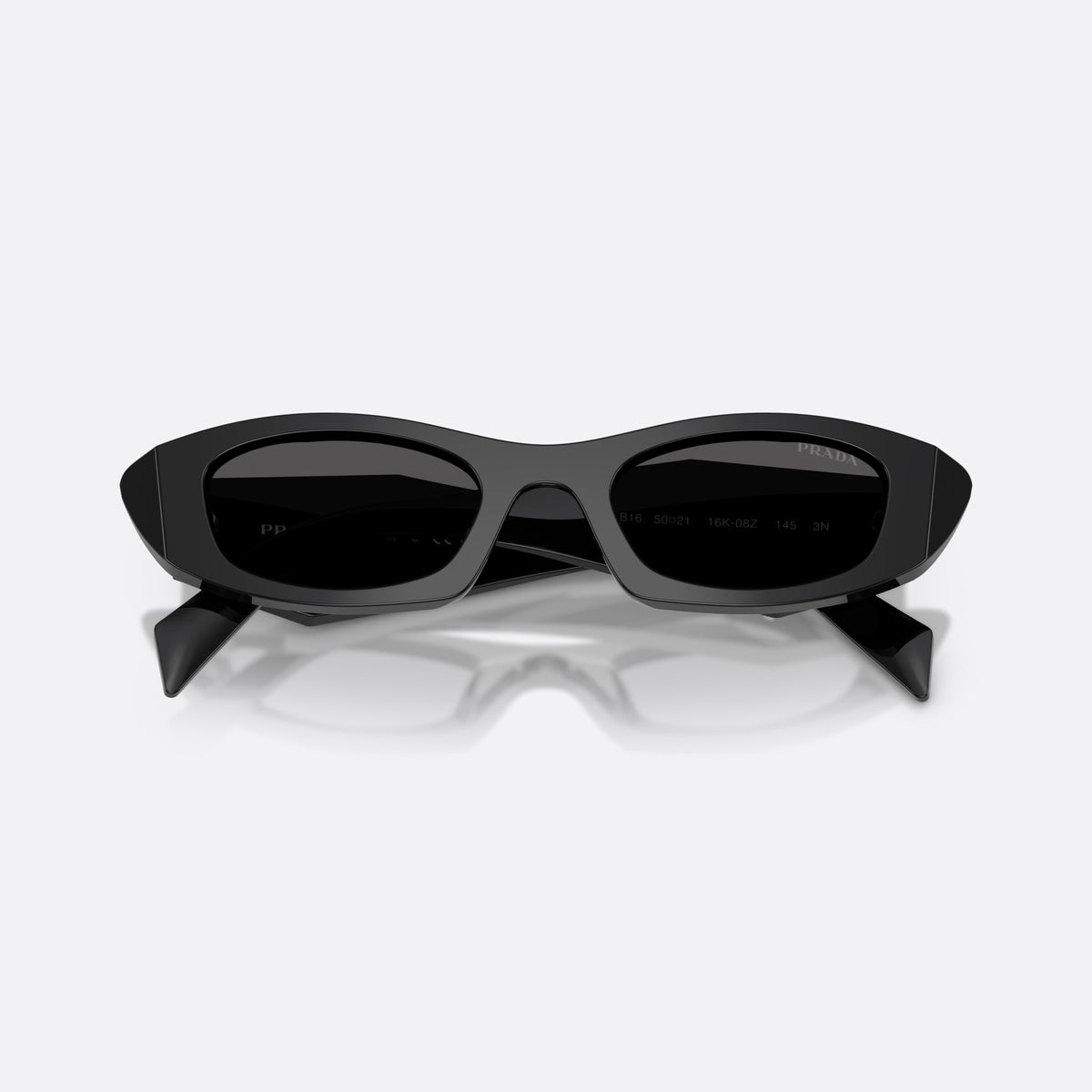 Prada PR B16S 16K08Z sunglasses, black oval frame for women, plain integrated bridge, brand lettering on temples, folded