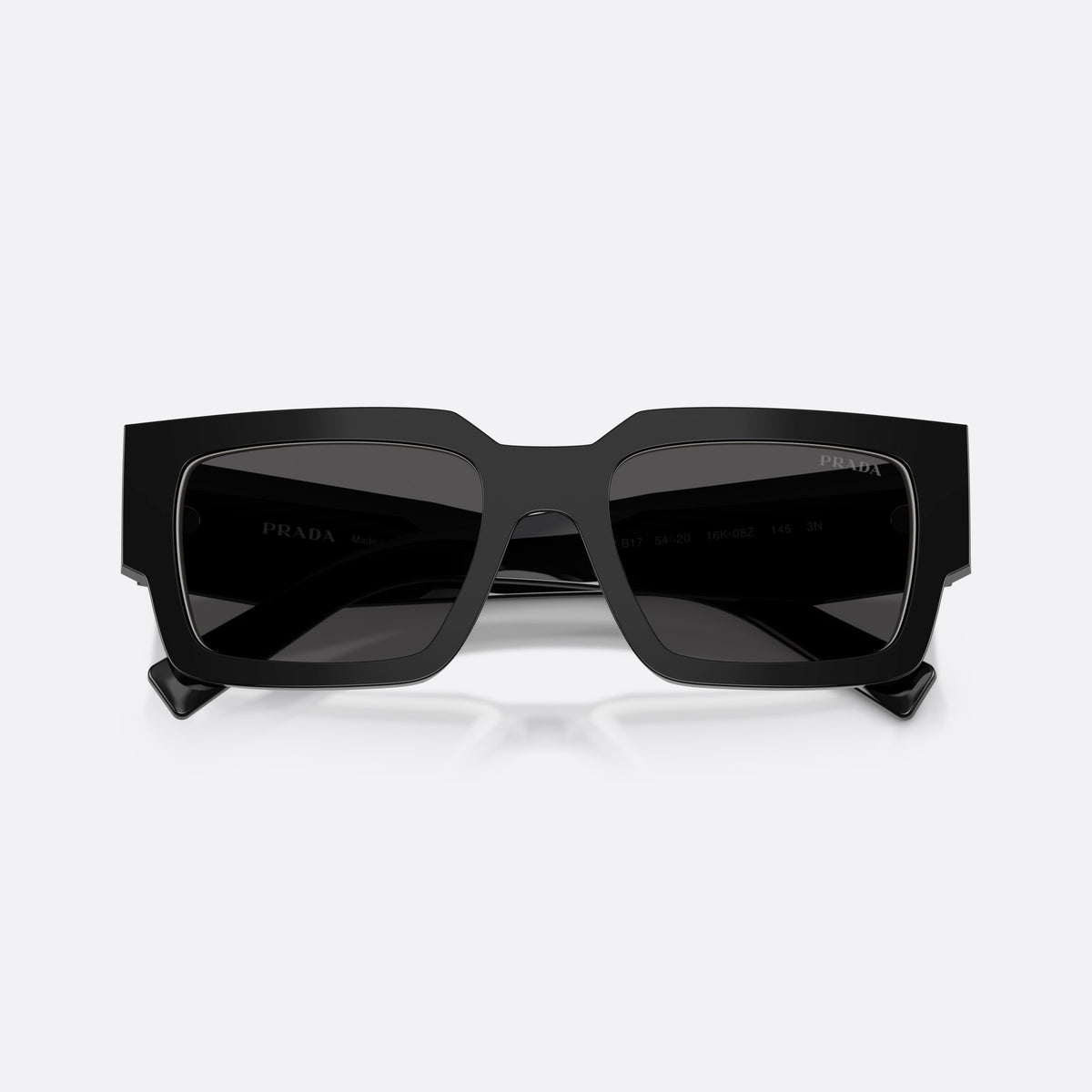 Prada PR B17S 16K08Z sunglasses, black rectangle frame for men, plain integrated bridge, brand lettering on temples, folded