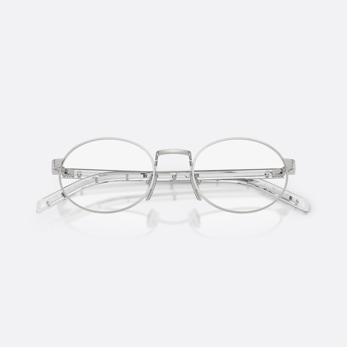 Rame ochelari de vedere Prada PR B55V 1BC1O1, ovali argintiu, pentru femei, punte metalică tip șa, literele brandului pe braț, cu brațele pliate