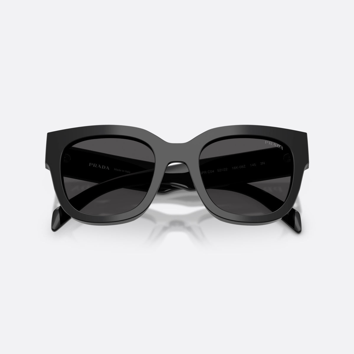 Prada PR C04S 16K08Z sunglasses, black square frame for women, plain integrated bridge, brand lettering on temples, folded