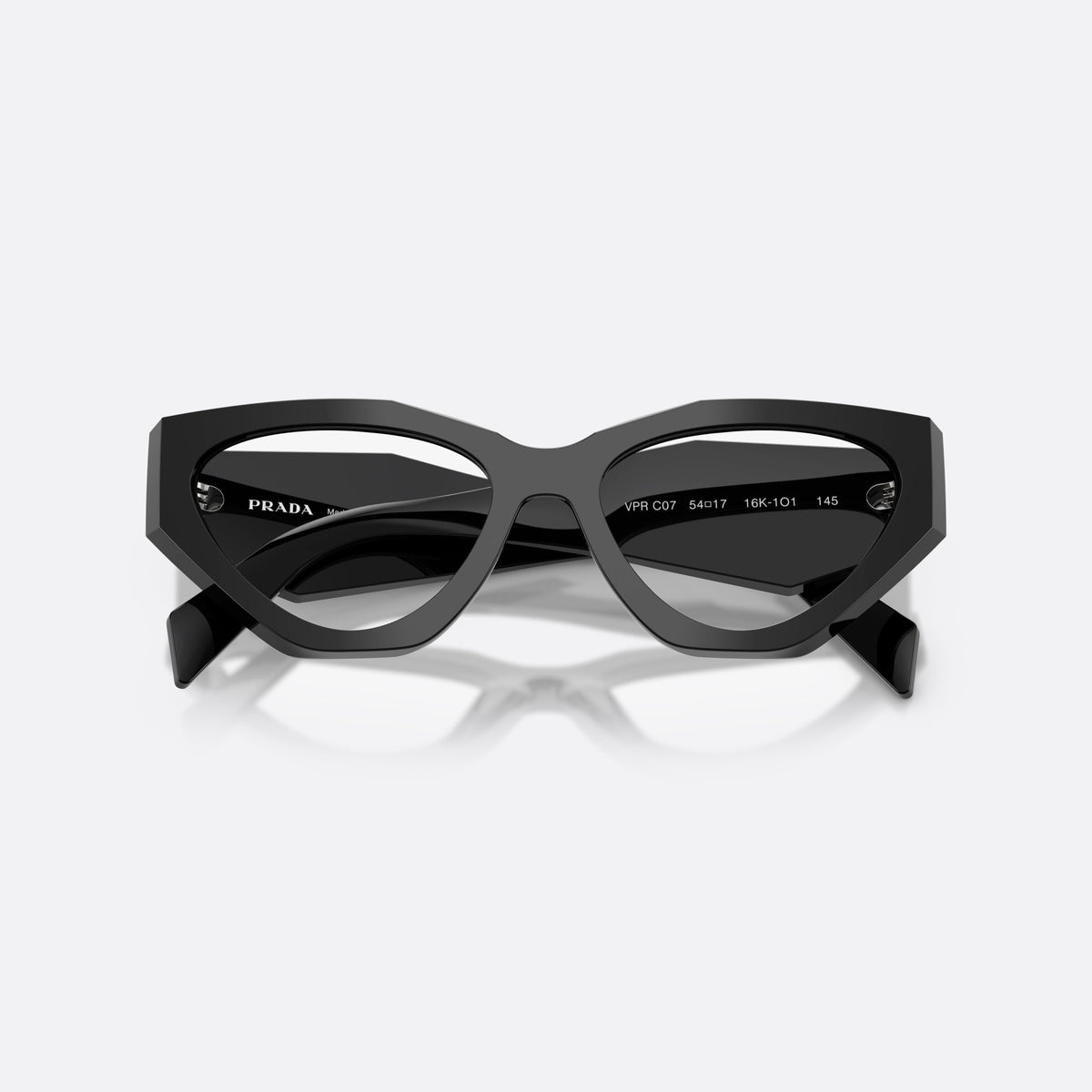 Prada PR C07V 16K1O1 eyeglasses, black irregular frame for women, plain integrated bridge, brand logo plaque on temple, folded