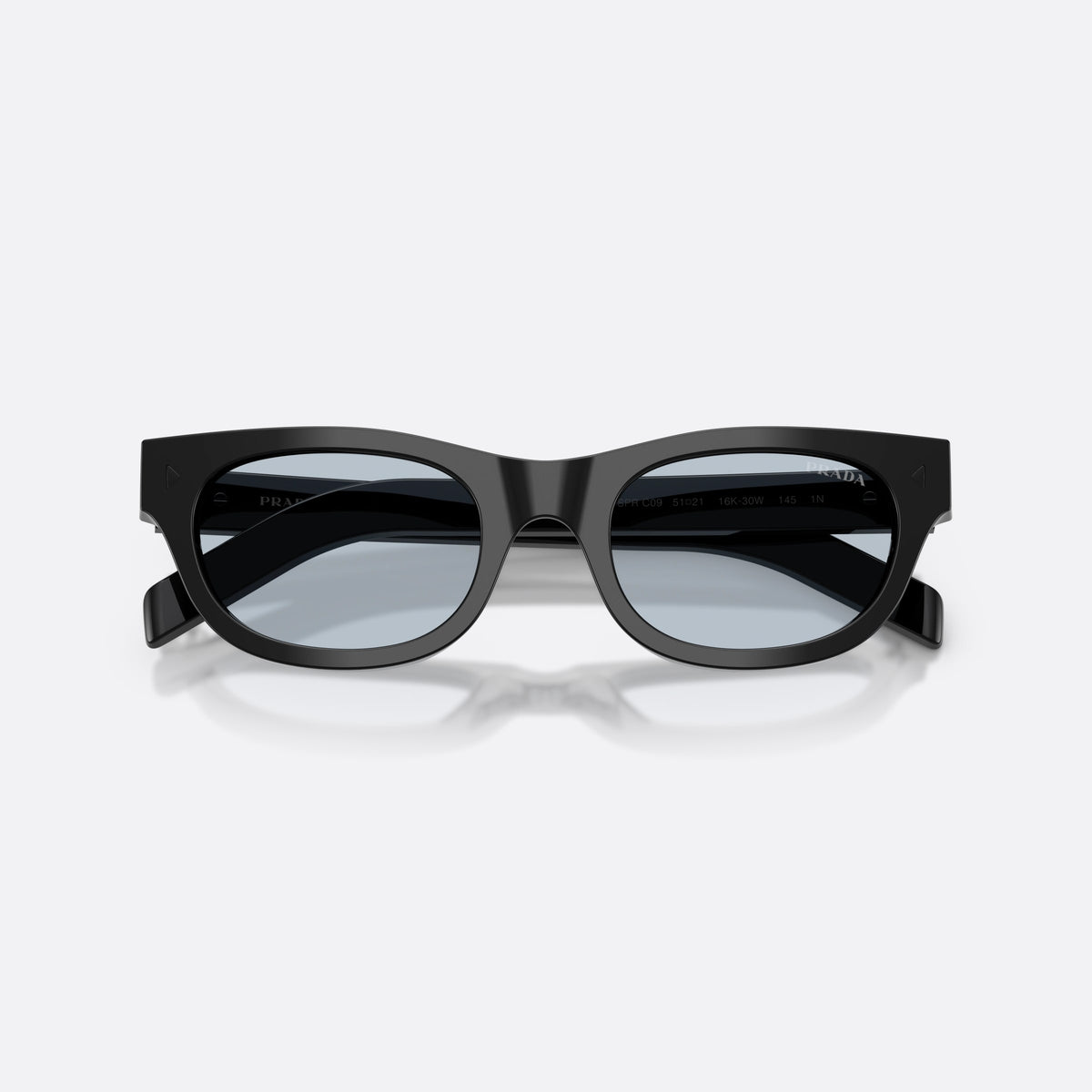 Prada PR C09S 16K30W sunglasses, black cat eye frame for men, keyhole bridge, brand lettering on temple, folded