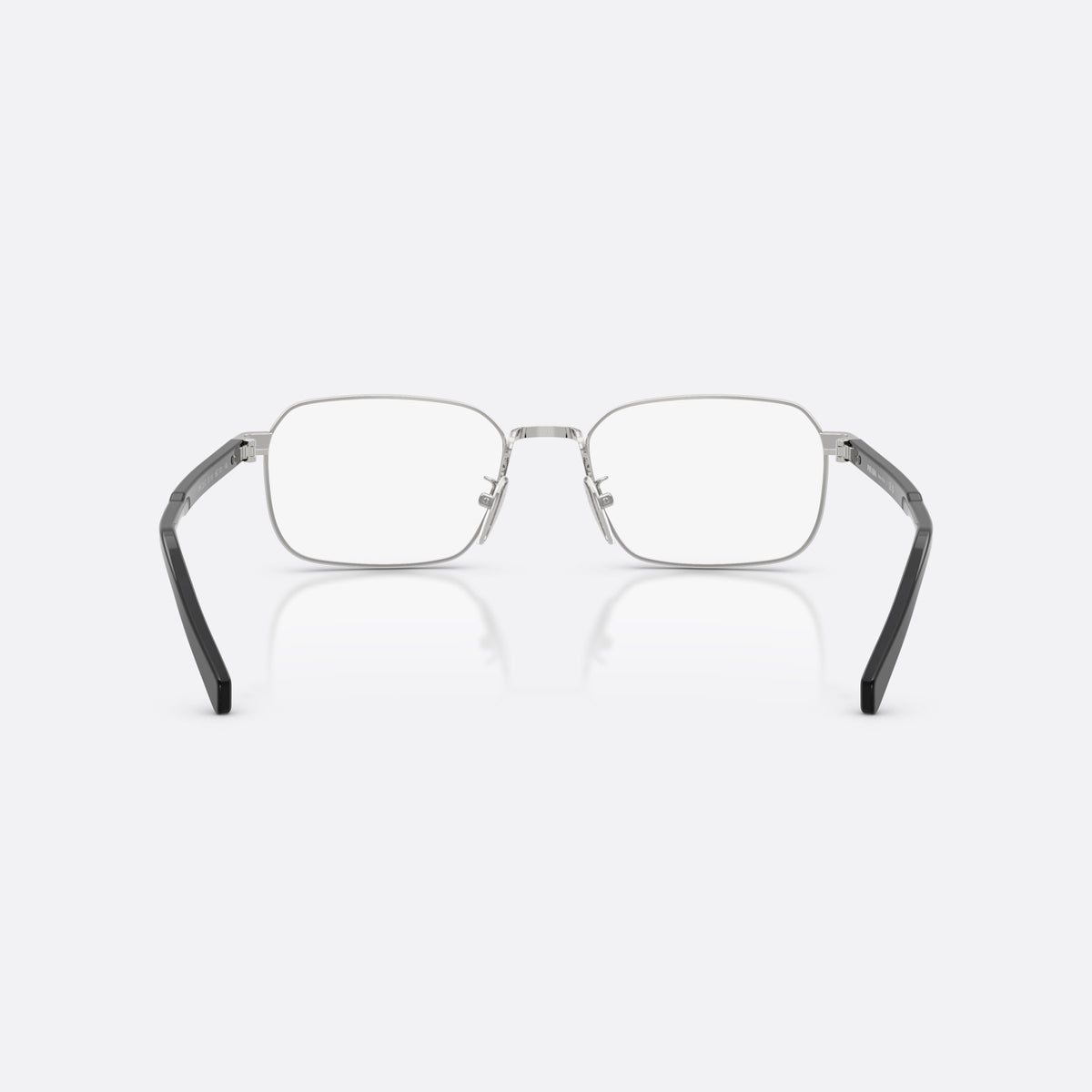 Prada PR C50VD 1BC1O1 eyeglasses, silver pillow frame for men, plain metal bridge, brand lettering on the temples, back view