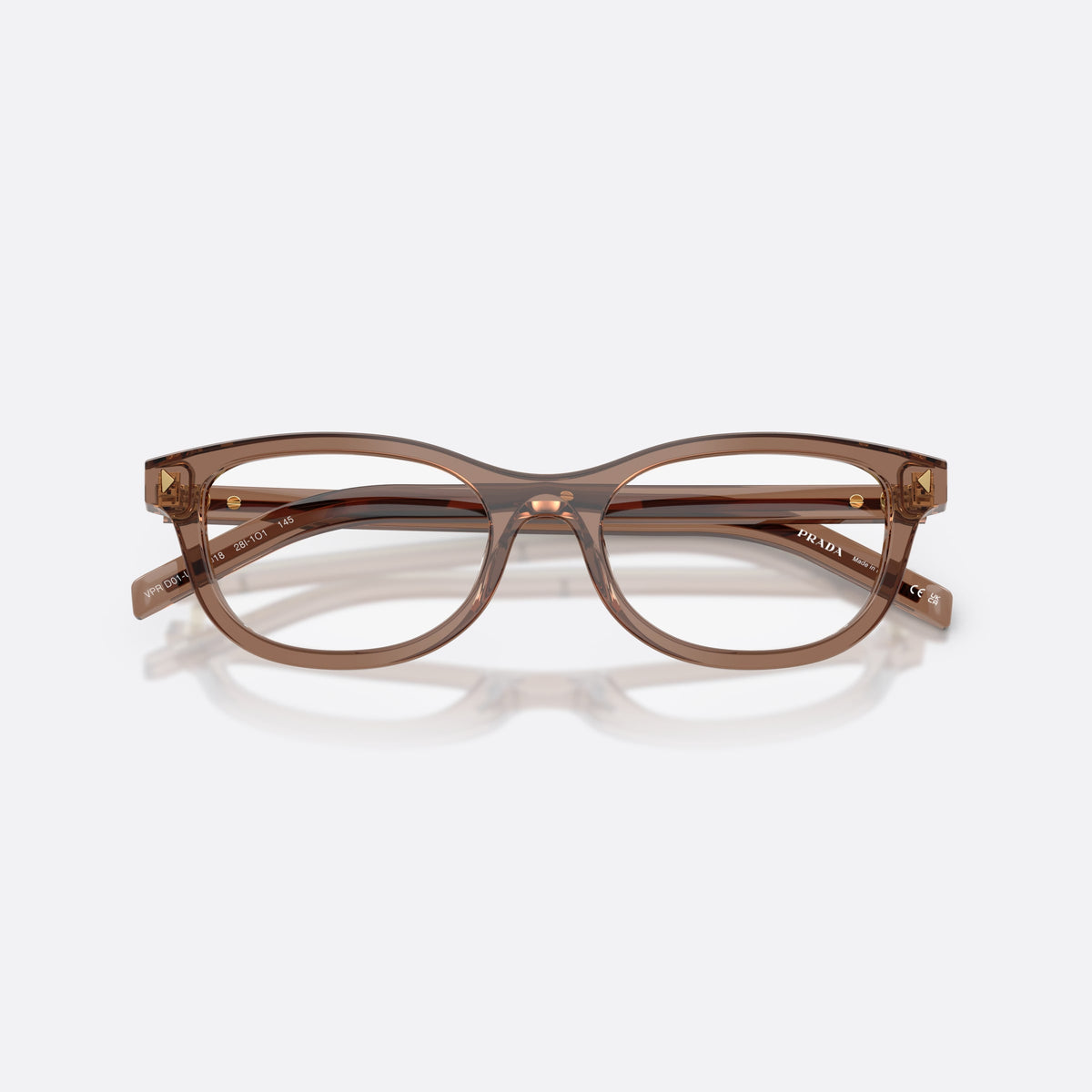 Prada PR D01VU 28I1O1 eyeglasses, clear oval frame for women, plain integrated bridge, brand lettering on temples, folded