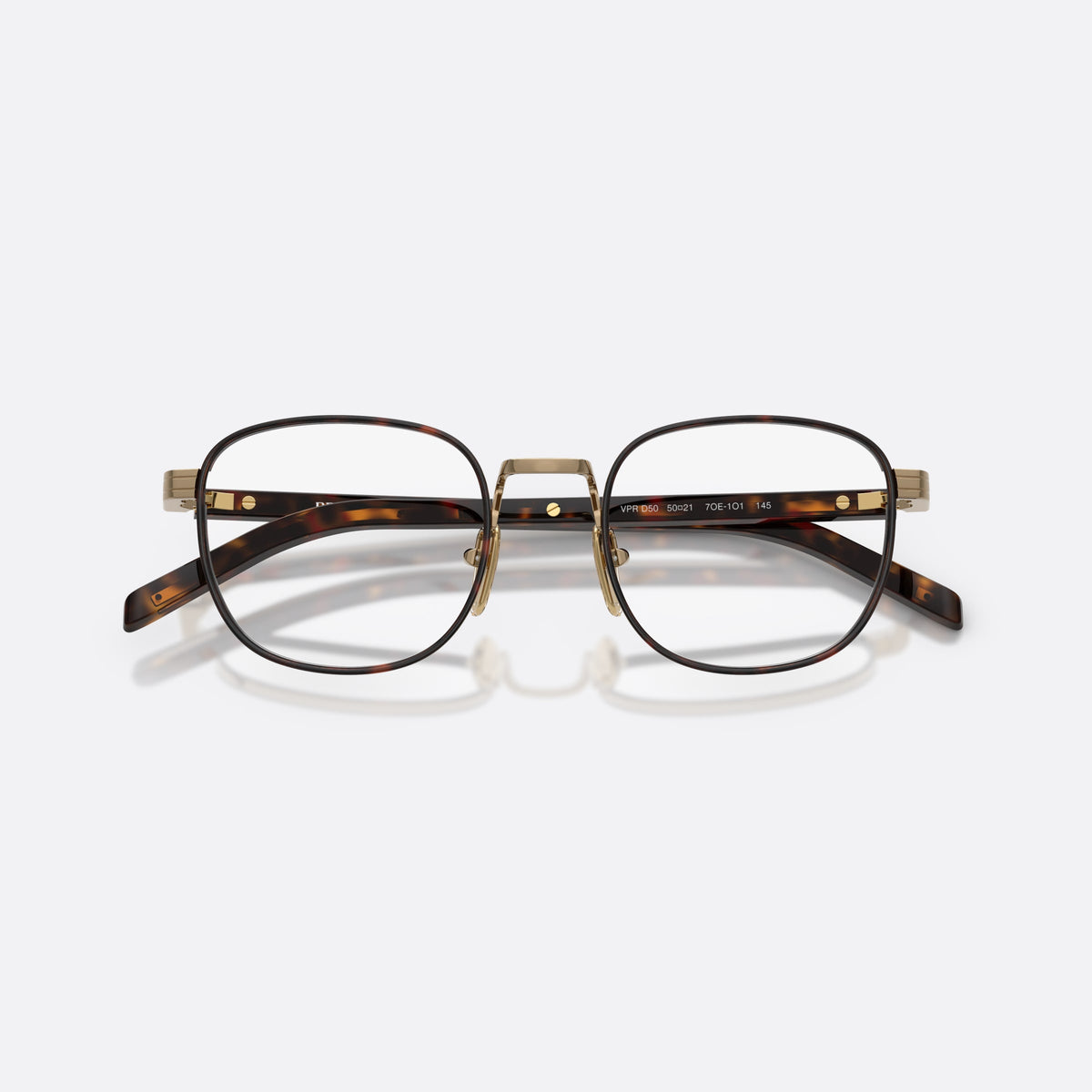 Prada PR D50V 7OE1O1 eyeglasses, gold phantos frame for men, metal saddle bridge, brand lettering on the temples, folded