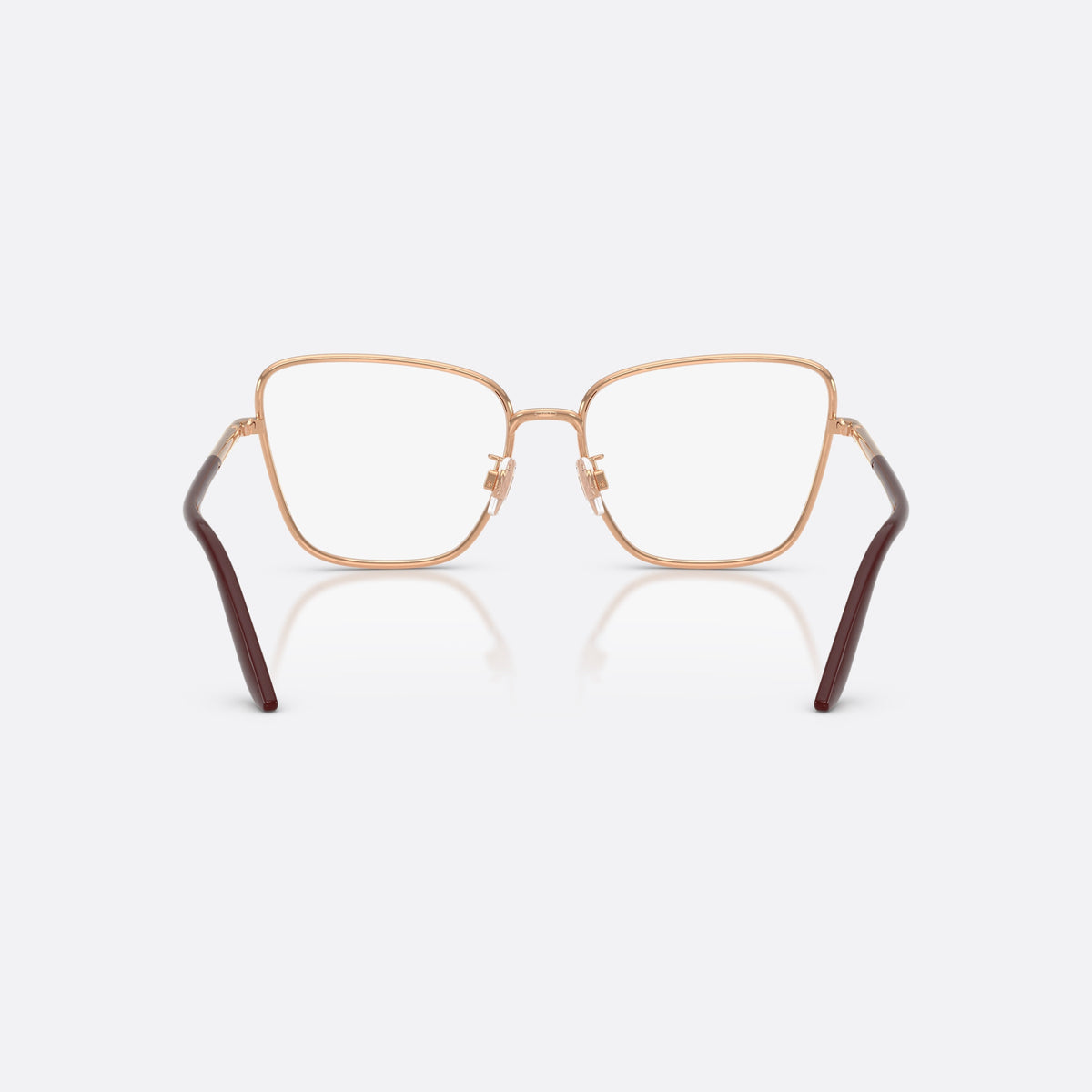 Dolce & Gabbana DG1359 1298 eyeglasses, gold cat eye frame for women, plain metal bridge, brand lettering on temples, back view