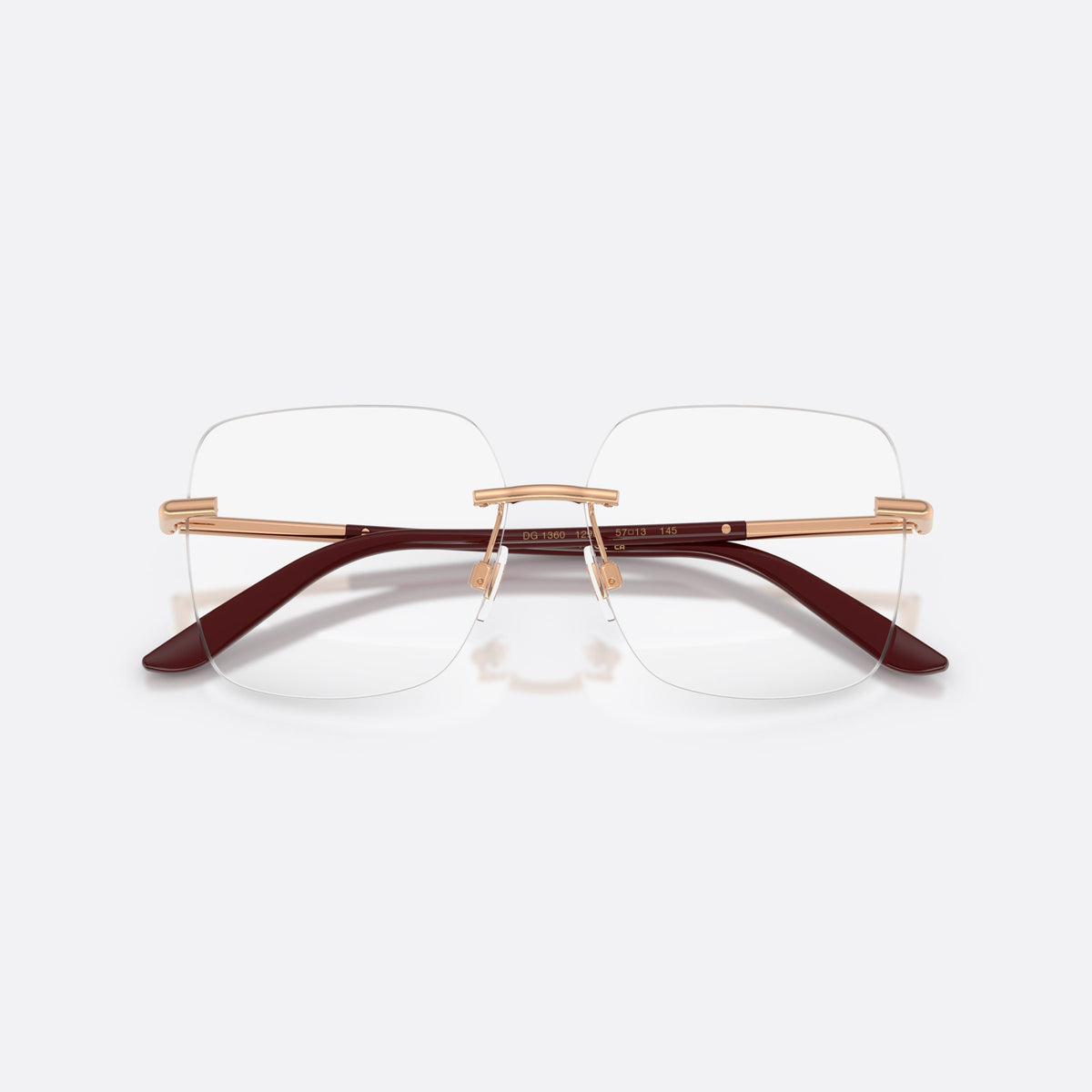 Dolce & Gabbana DG1360 1298 eyeglasses, gold square frame for women, plain metal bridge, brand lettering on temples, folded