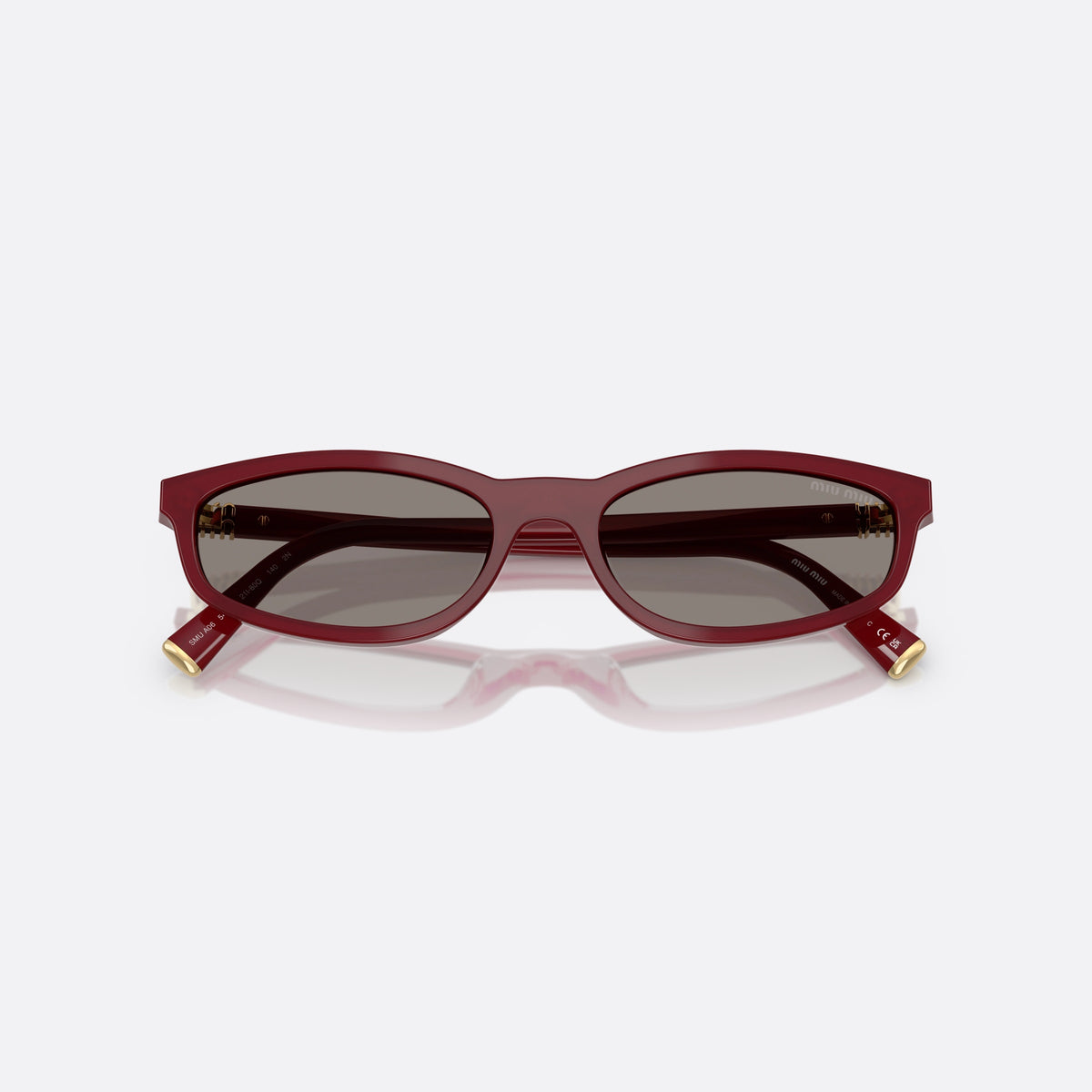 Miu Miu MU A06S 21I80Q sunglasses, red irregular frame for women, plain integrated bridge, brand lettering on temples, folded