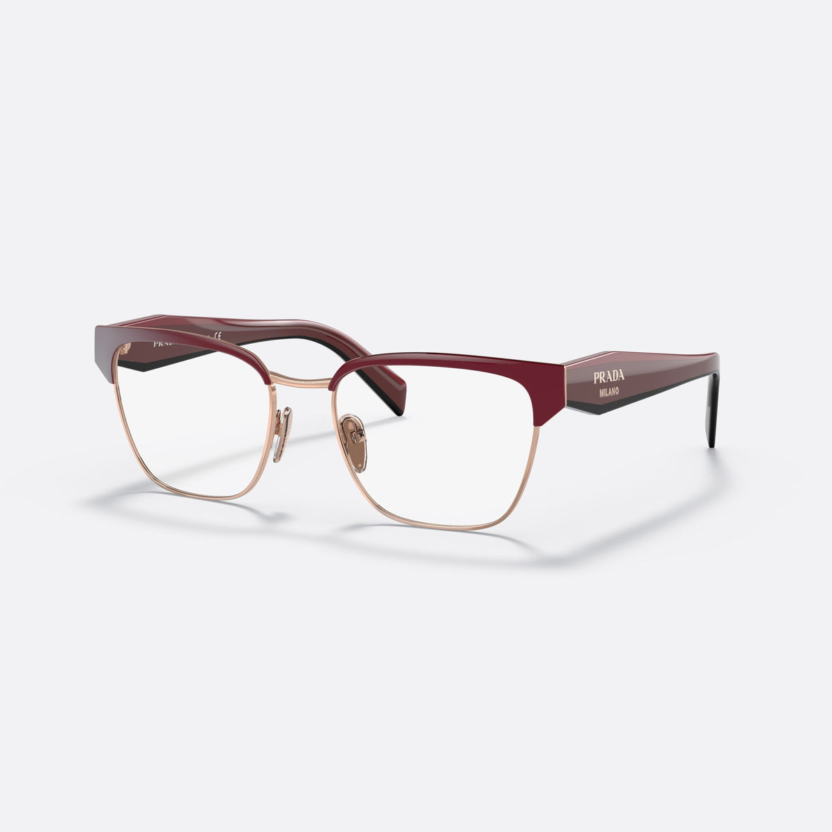 Prada PR 65YV 16A1O1 eyeglasses, red irregular frame for women, saddle-style metal bridge, brand lettering on the temples