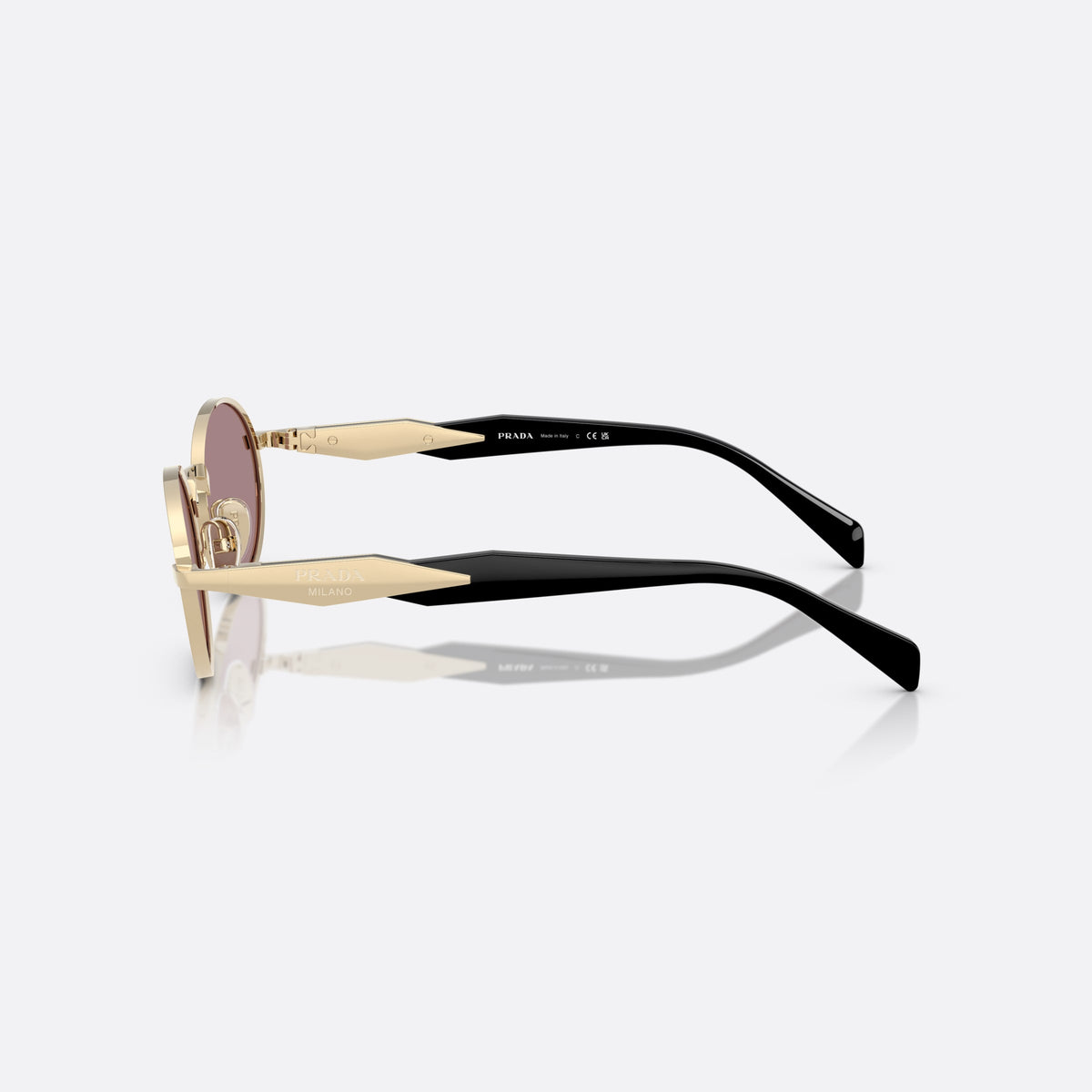 Prada PR 65ZS ZVN-20I sunglasses, gold oval frame, unisex, plain metal bridge, brand lettering on temples, side view