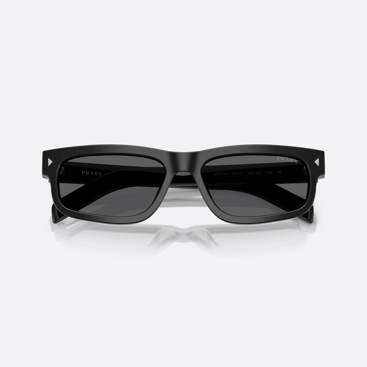 Prada PR B11S 16K731 sunglasses, black rectangle frame for men, plain integrated bridge, brand lettering on temples, folded