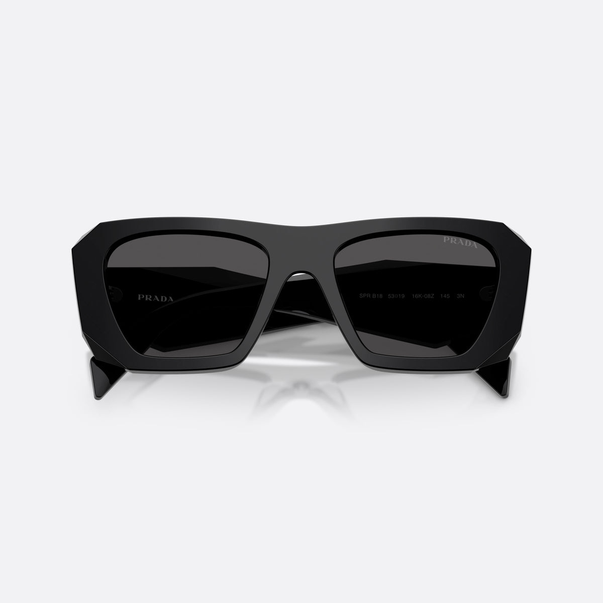 Prada PR B18S 16K08Z sunglasses, black square frame for women, plain bridge, brand lettering on temples, full rim, folded