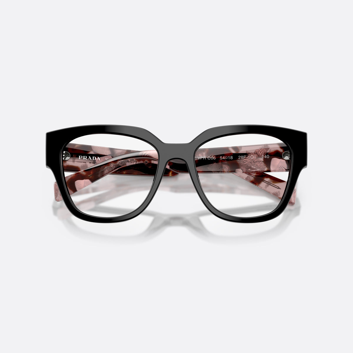 Prada PR C06V 28F1O1 eyeglasses, black oval frame for women, plain saddle bridge, brand lettering on temples, folded