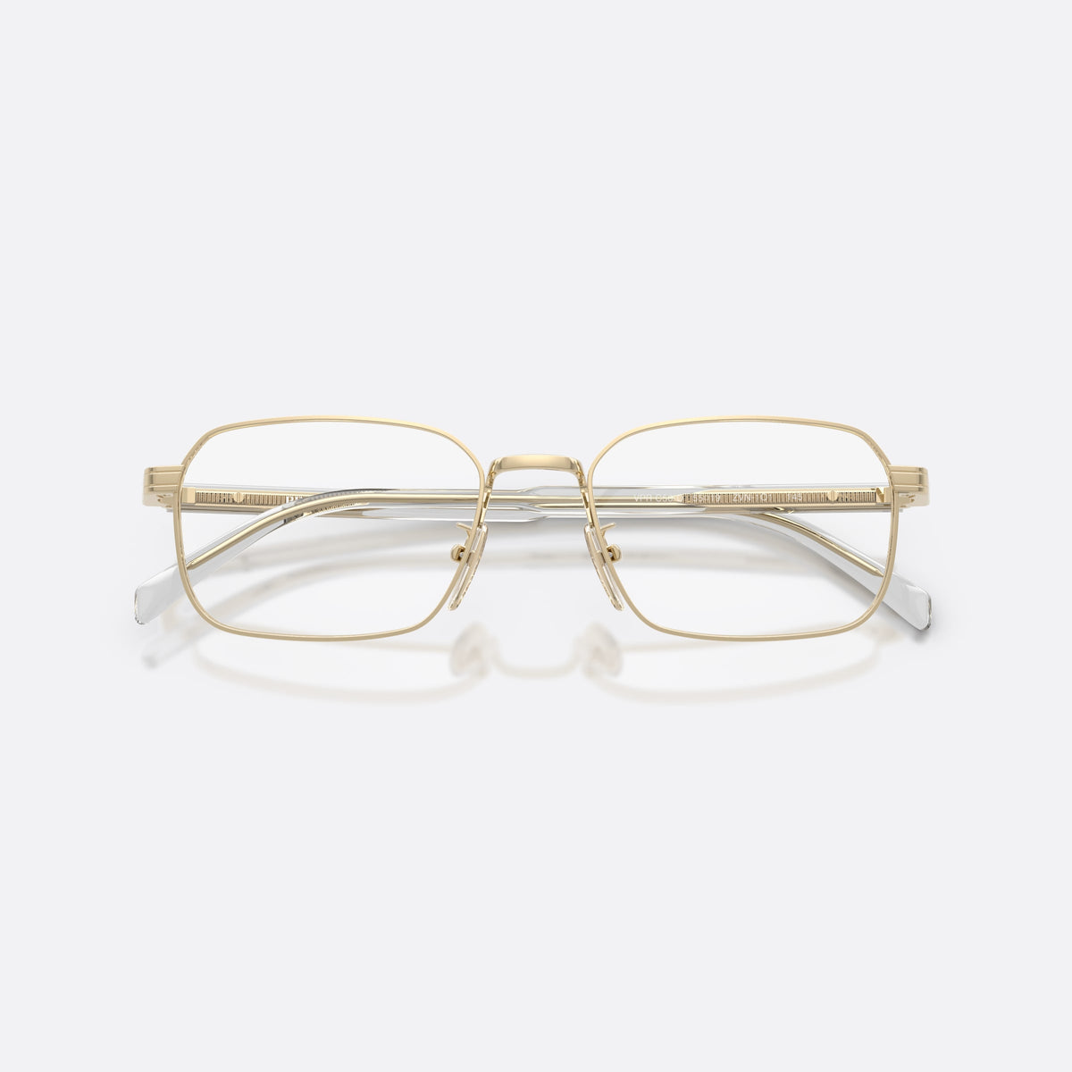 Prada PR C50VD ZVN1O1 eyeglasses, gold pillow frame for men, plain metal bridge, brand lettering on temples, folded